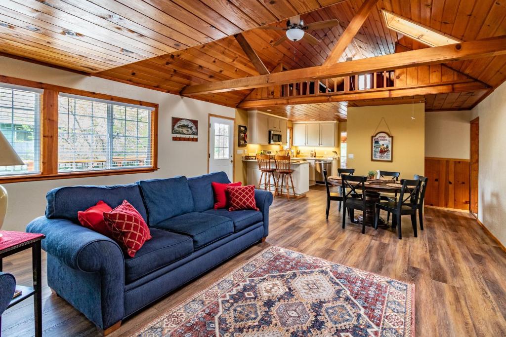 a living room with a blue couch and a dining room at Brier Escape in Bass Lake