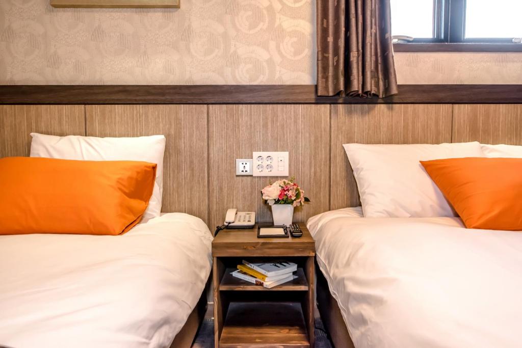 Postel nebo postele na pokoji v ubytování Index Hotel J Dream Jeju