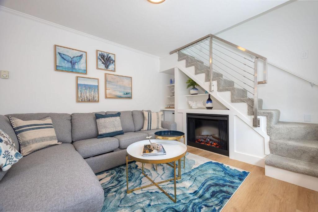 a living room with a couch and a fireplace at Nantucket Penthouse - walk to restaurants beaches activies & so much more in Half Moon Bay