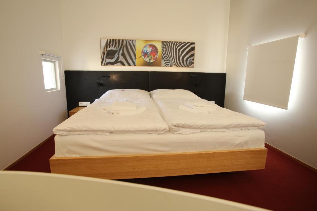 Postel nebo postele na pokoji v ubytování Hotel Purkmistr