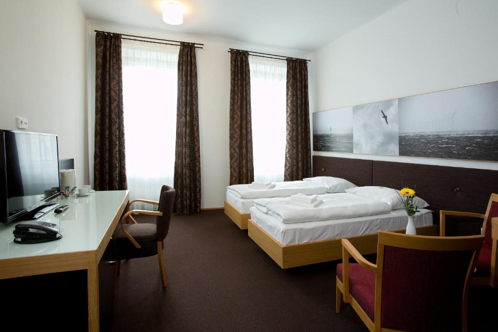 Postel nebo postele na pokoji v ubytování Hotel Purkmistr