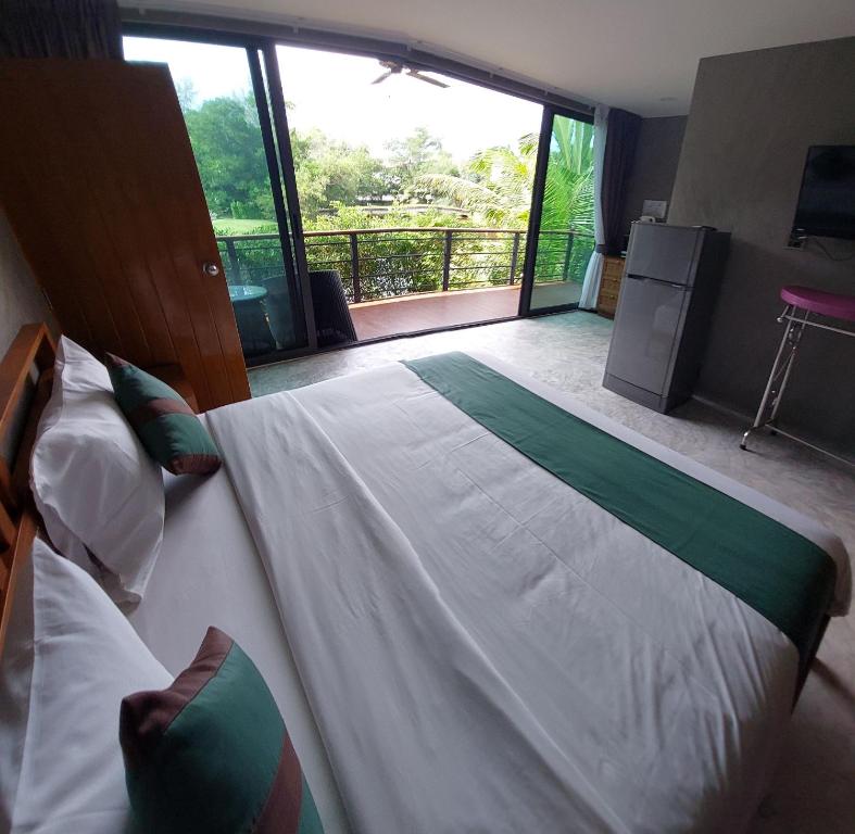 Postel nebo postele na pokoji v ubytování The Touch Green Naiyang Hotel & Fitness