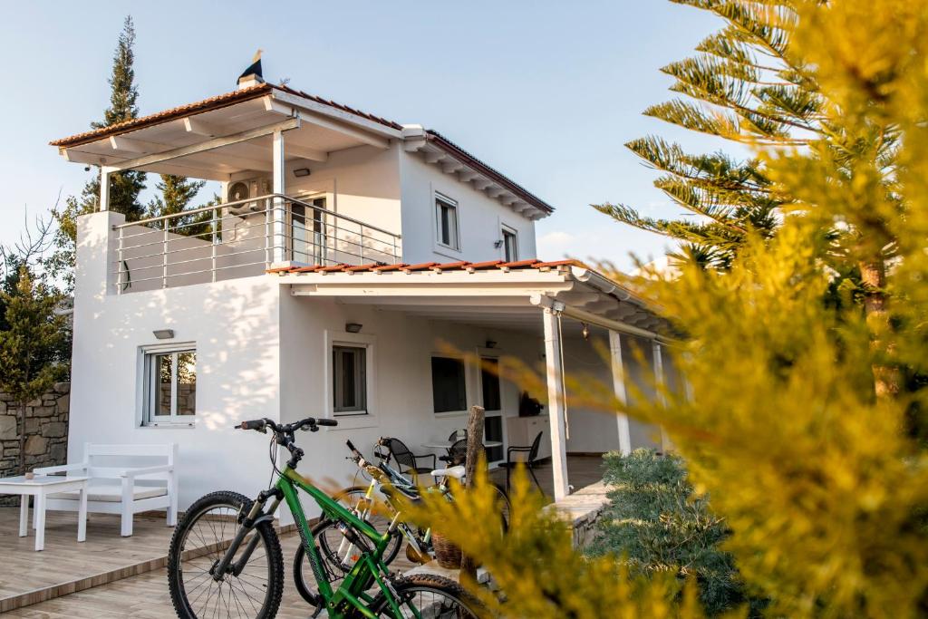 ein Haus mit zwei Fahrrädern davor geparkt in der Unterkunft Villa Liostasi in Lagolíon