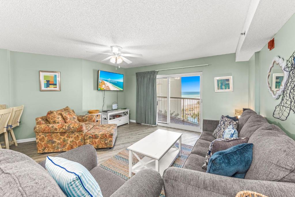 a living room with a couch and chairs at Tradewinds Unit 406 in Orange Beach