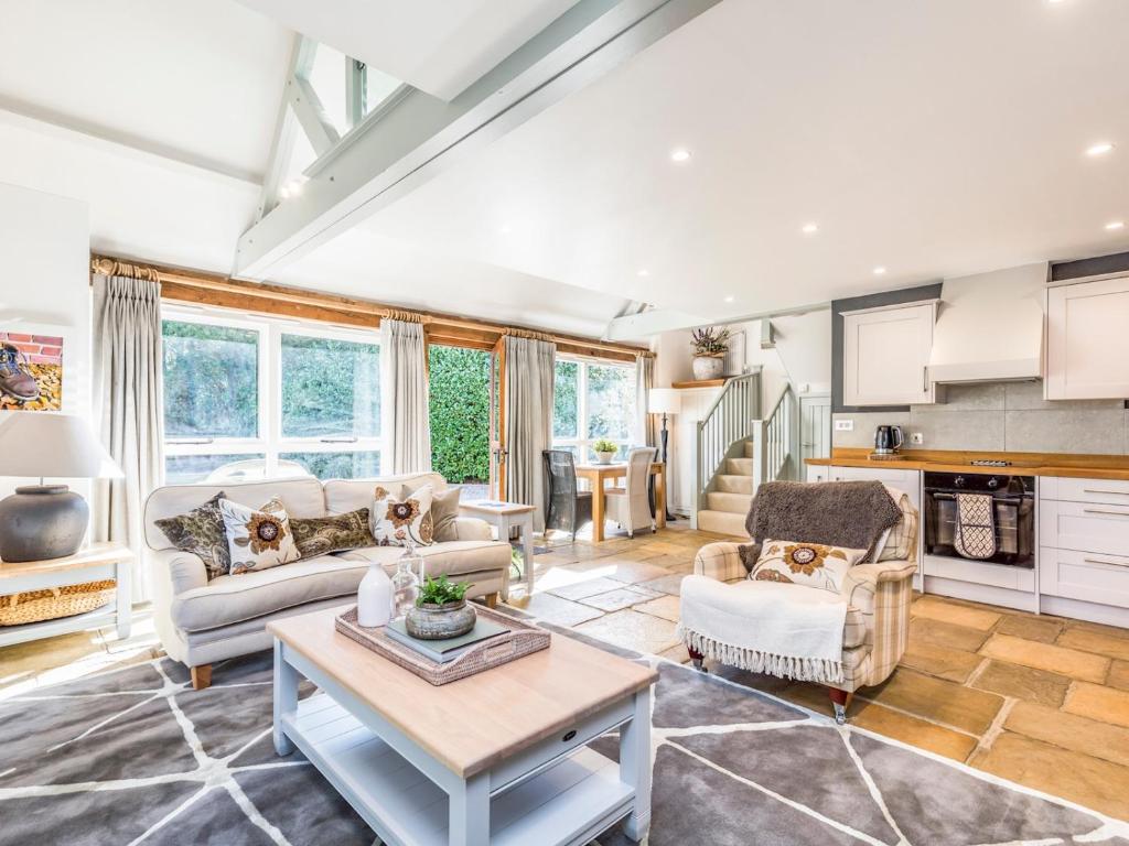 a living room with two couches and a table at Pass the Keys Peaceful and beautiful 1 bedroom barn conversion in Chichester