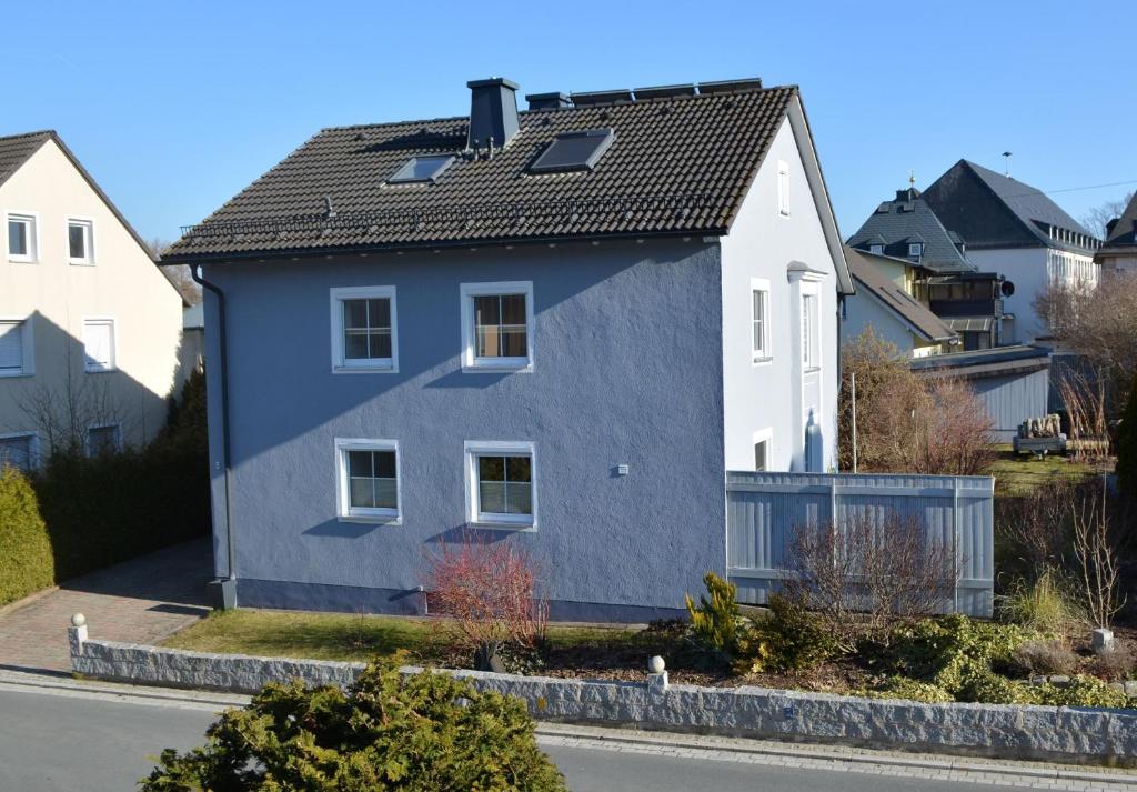 a blue house on the side of a street at Fewo Bauer in Oberkotzau