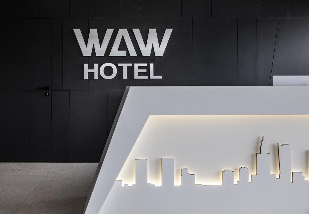 a white table in front of a way hotel sign at Waw Hotel Airport Okęcie in Warsaw