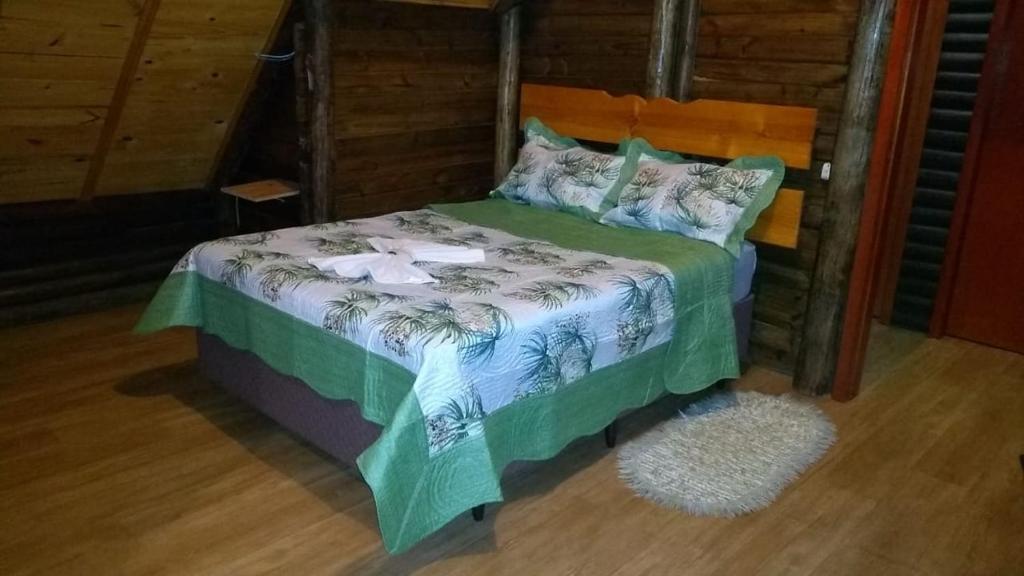 um quarto com uma cama num quarto em CHALÉ ESTÂNCIA OURO VERDE em Lages