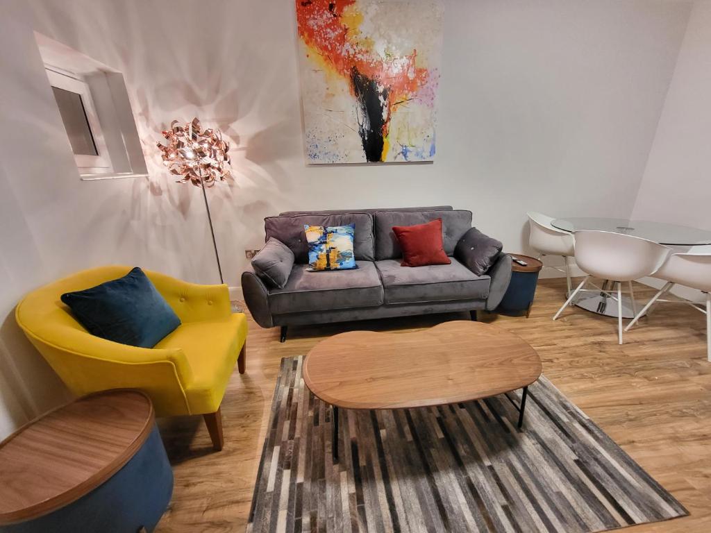 a living room with a couch and a table at Garland Contemporary Central London Apartment in London