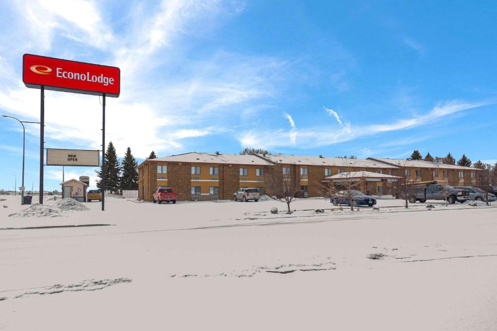 a sign in front of a building in the snow at Econo Lodge in Williston