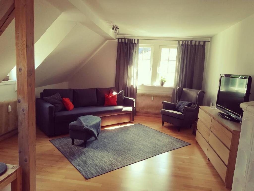 a living room with a couch and two chairs at Wohnen bei den Brückenhäusern in Bad Kreuznach