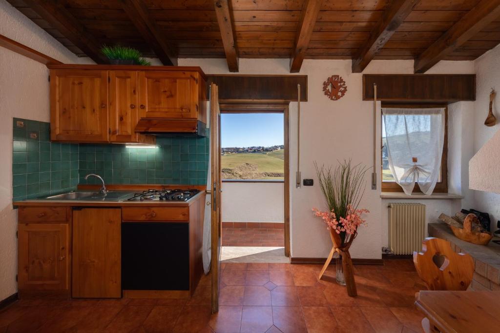 a kitchen with a sink and a stove top oven at ASIAGO - Chalet panoramico con Wifi e Free Parking in Gallio