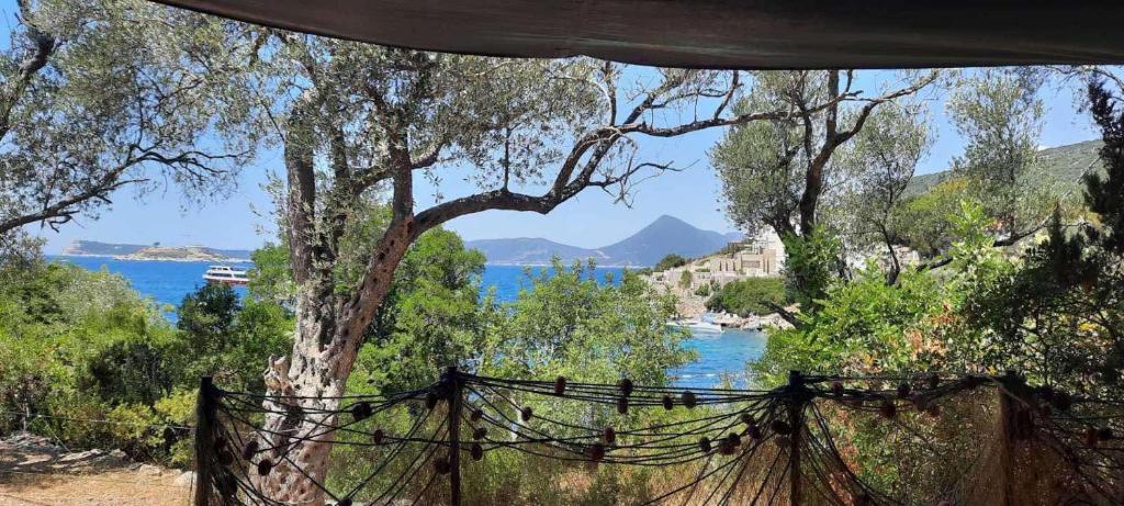 a hammock in front of a view of the water at Apartmani Roganovic in Luštica
