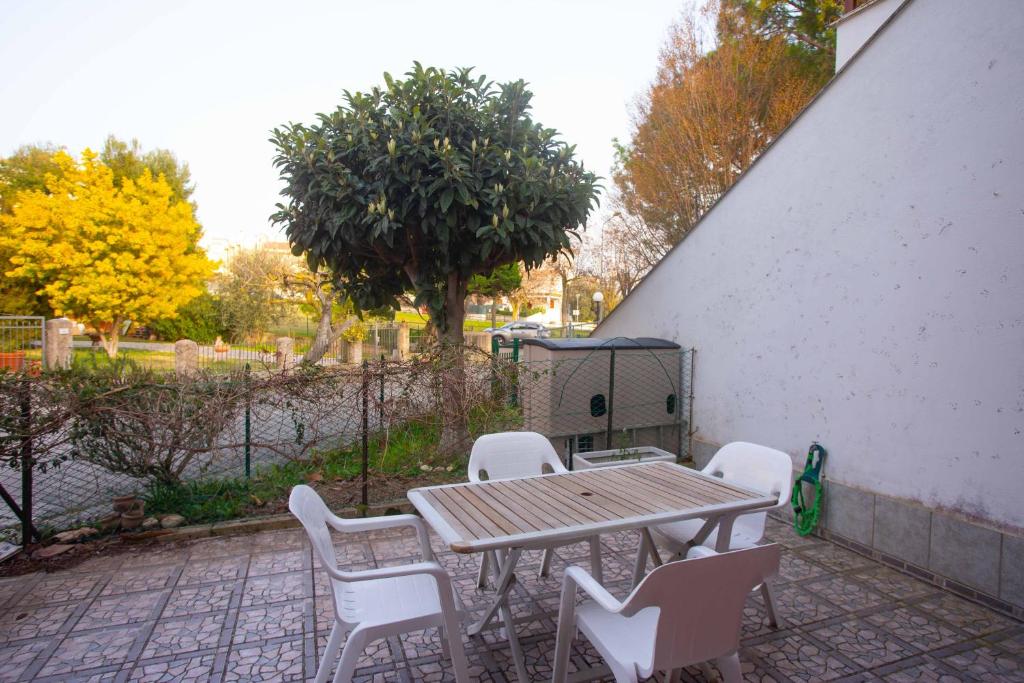 a wooden table and chairs on a patio at M278 - Marcelli, delizioso bilocale con terrazzo in Marcelli