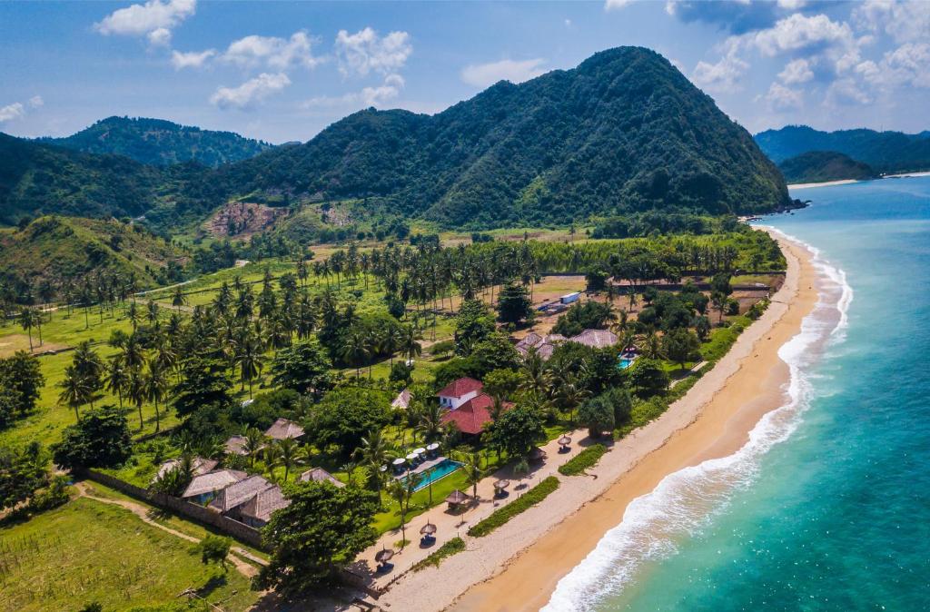 an aerial view of the shoreline of a beach at Segara Lombok Beach Resort in Selong Belanak