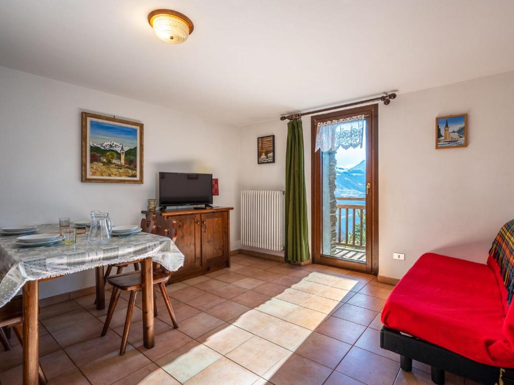 a living room with a table and a couch at Apartment Grand Sarriod-5 by Interhome in Saint Nicolas