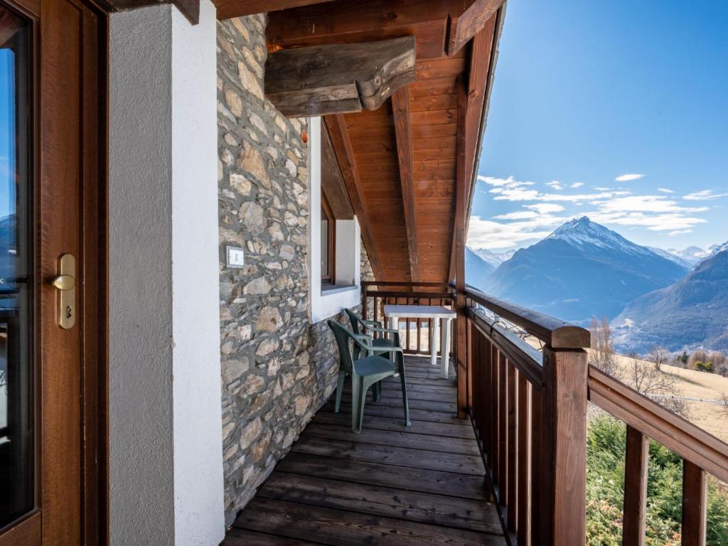a balcony of a house with a view of mountains at Apartment Grand Sarriod-2 by Interhome in Saint Nicolas