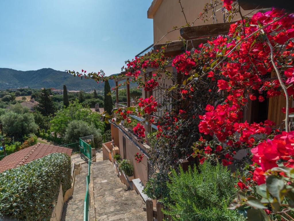una casa con fiori rossi su un lato di Apartment Casa Casu by Interhome a Solanas