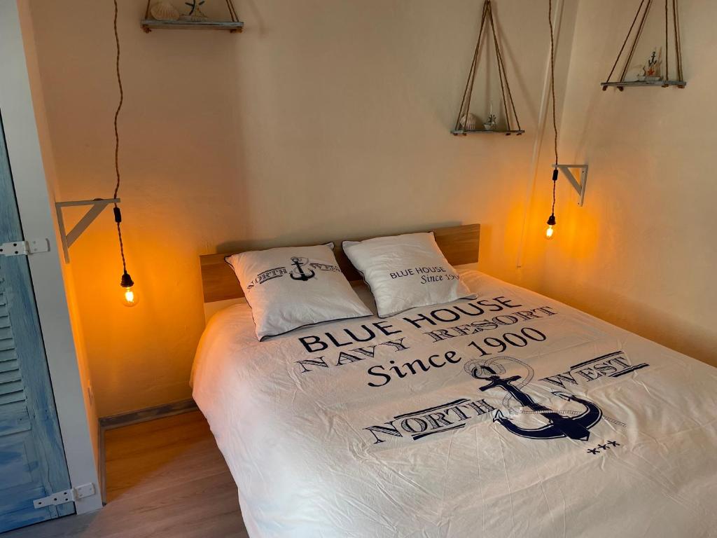 a bedroom with a bed with two pillows on it at Ocean ROOM in Romans-sur-Isère