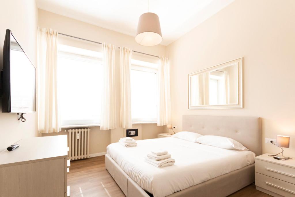A bed or beds in a room at Via Torino Apartment 2