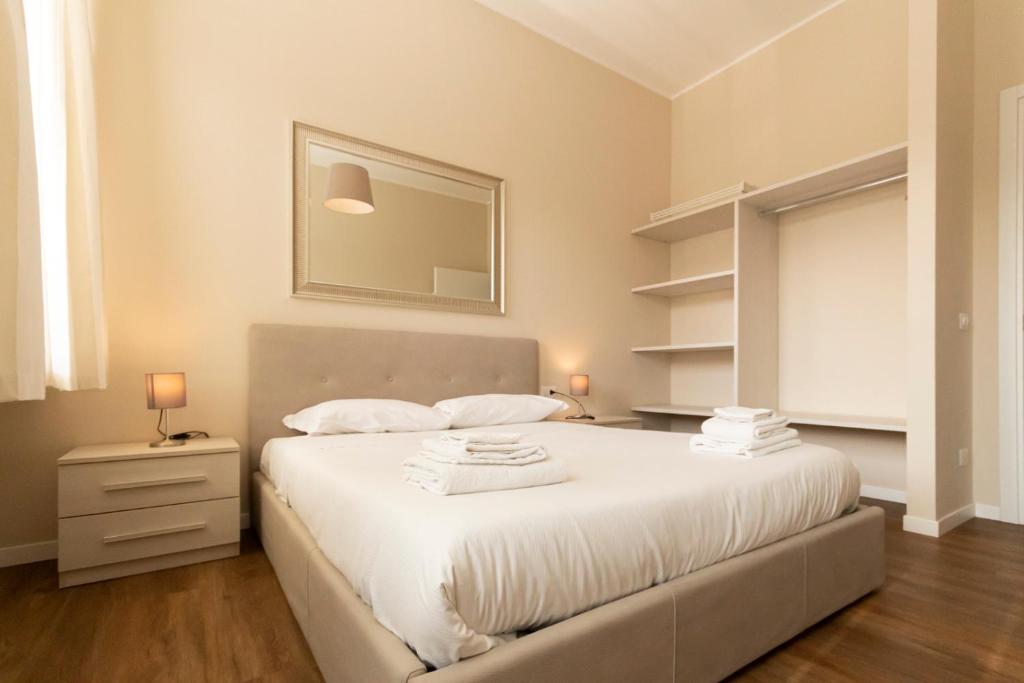 A bed or beds in a room at Via Torino Apartment 2