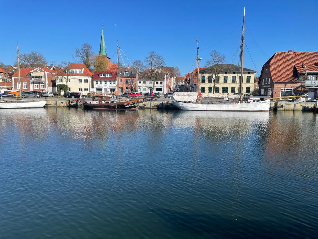 a group of boats docked in a harbor with buildings at Pier 67 Neustadt in Neustadt in Holstein