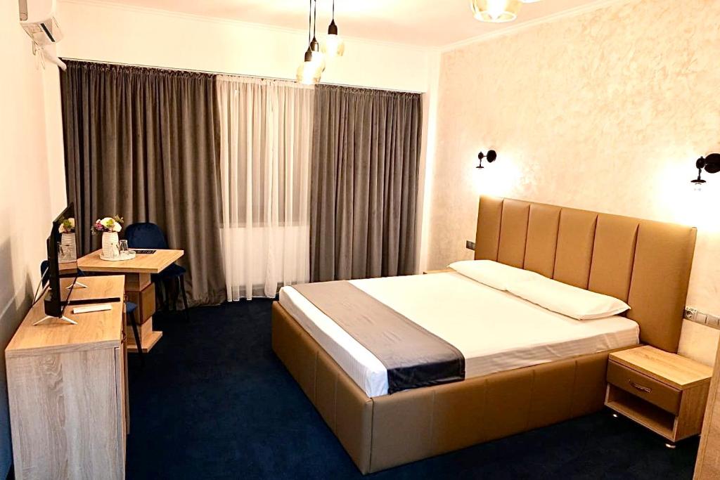 Postel nebo postele na pokoji v ubytování Villa Ovidiu