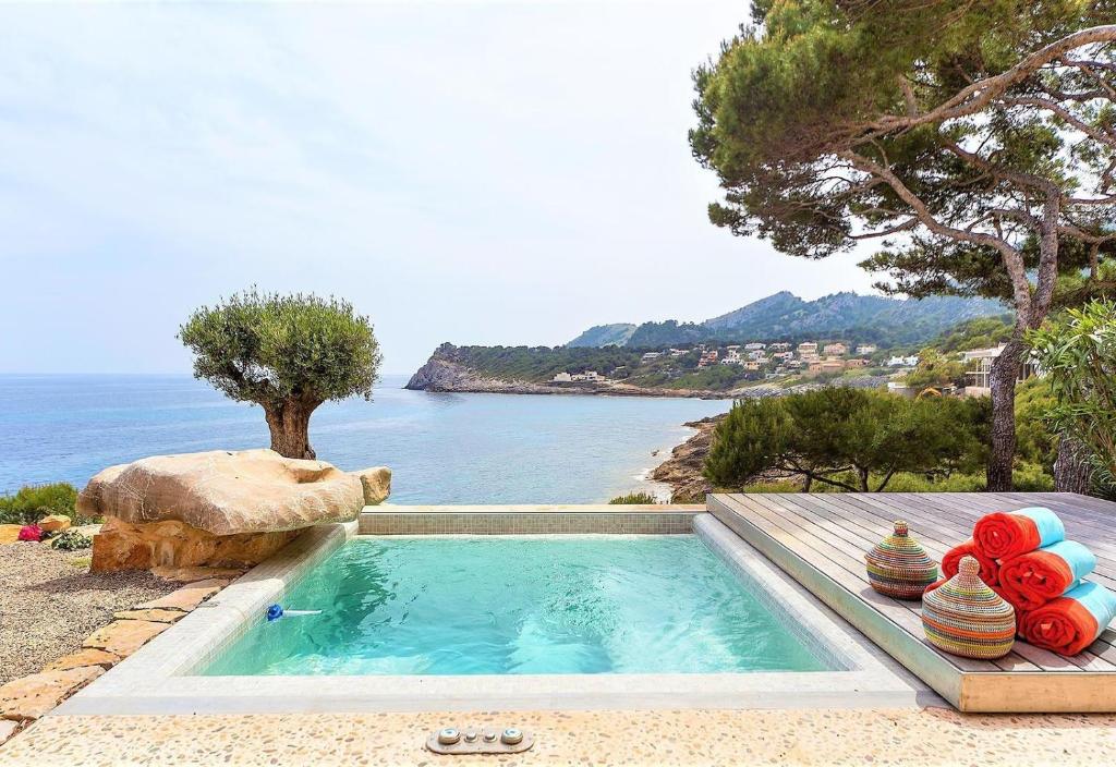 a swimming pool with a view of the ocean at Seaside in Capdepera