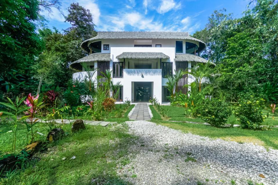 a large white house with a driveway at Makara Suite Penthouse in Uvita