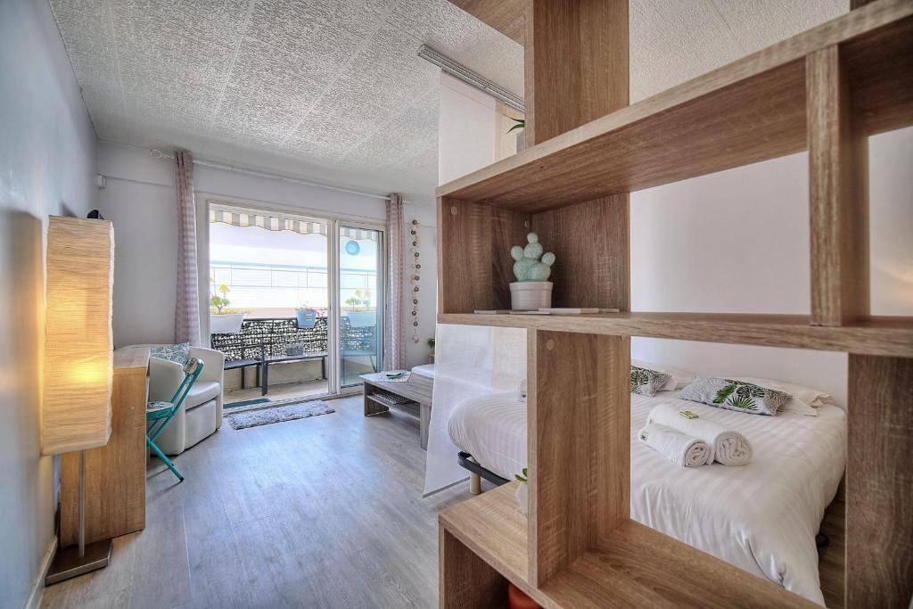 a bedroom with a bunk bed with wooden shelves at IMMOGROOM - Near the city centre and the beach - Air conditioning - Terrace in Cannes