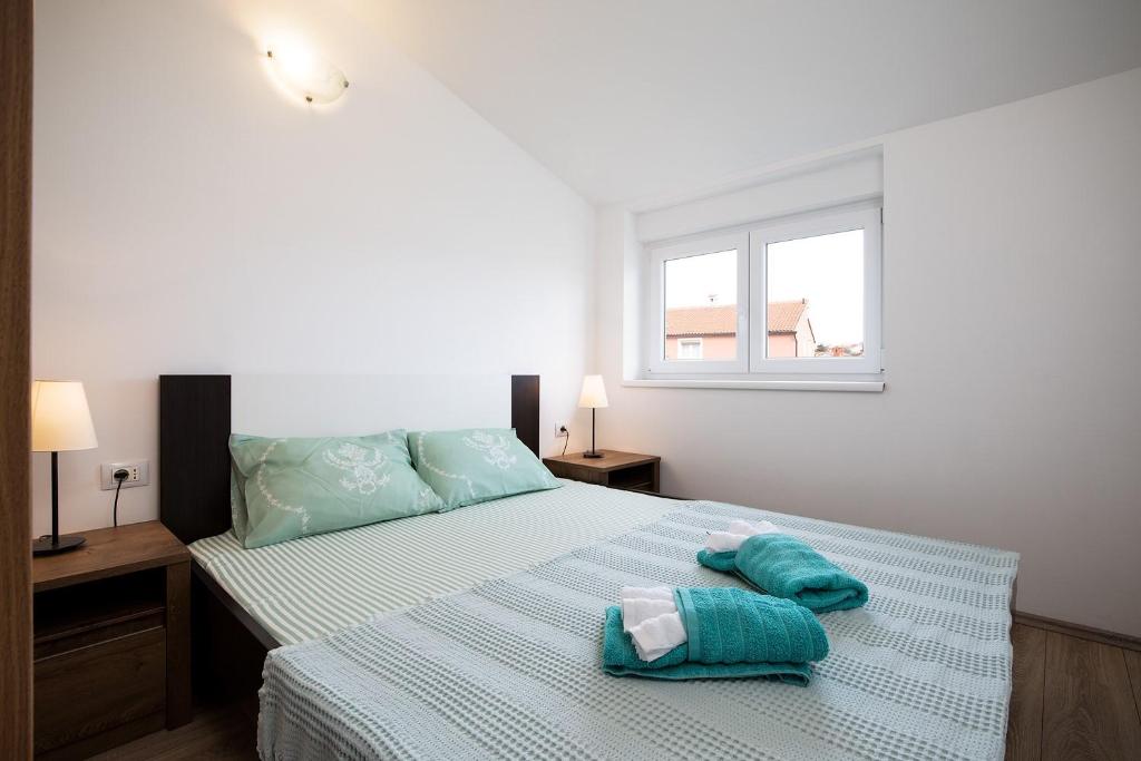 Postel nebo postele na pokoji v ubytování Apartments Jakoplić
