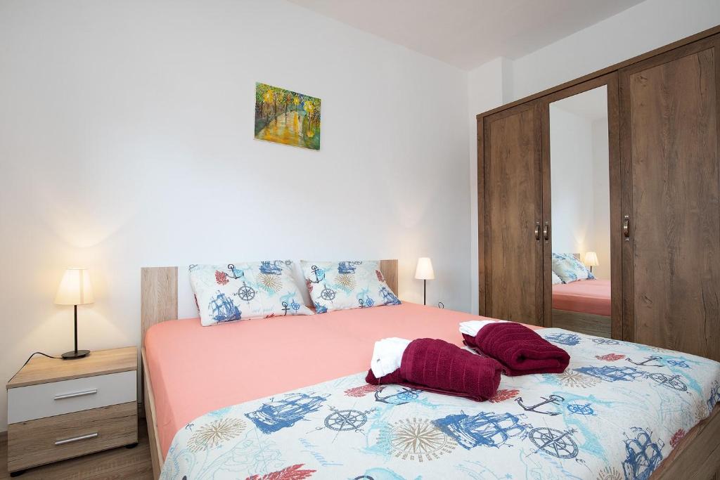 Postel nebo postele na pokoji v ubytování Apartments Jakoplić
