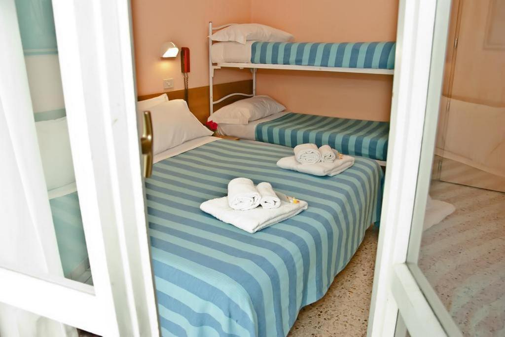 Postel nebo postele na pokoji v ubytování Hotel Staccoli