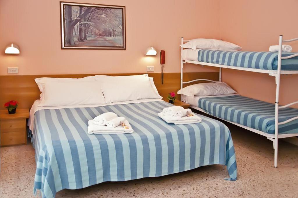 מיטה או מיטות בחדר ב-Hotel Staccoli
