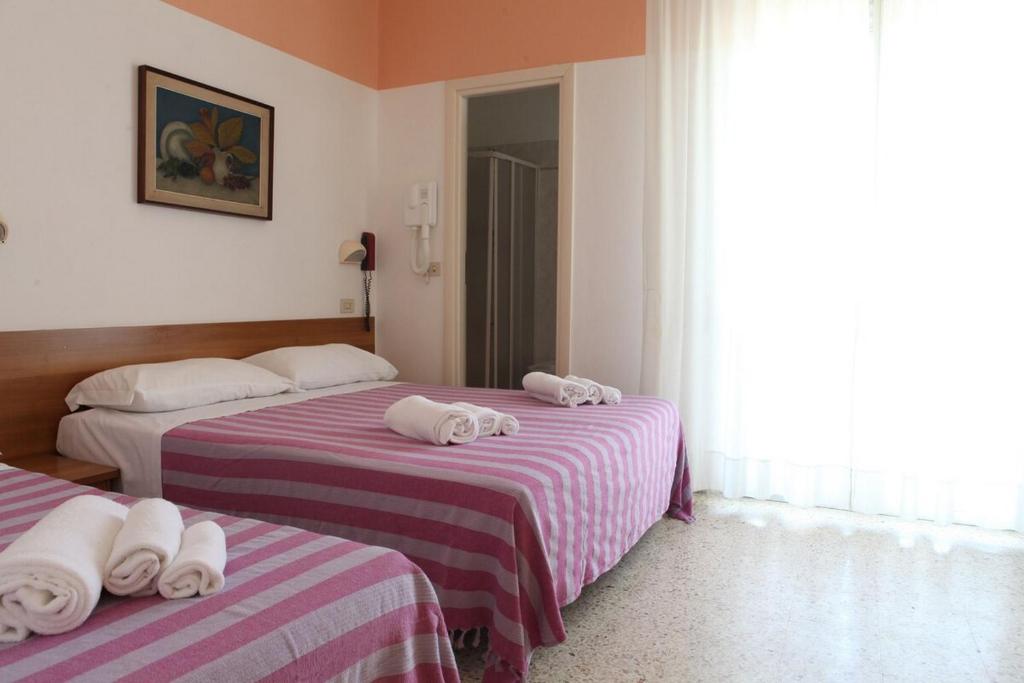 Postel nebo postele na pokoji v ubytování Hotel Staccoli