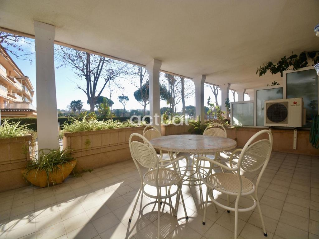 a porch with a table and chairs on a patio at Gavina Esc B Bajos B in Sant Feliu de Guixols