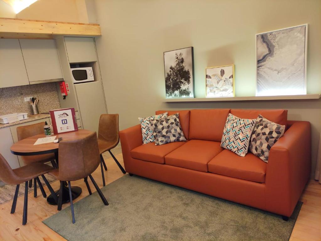 un soggiorno con divano e tavolo di BRA com Apartments Oporto House 68 a Porto