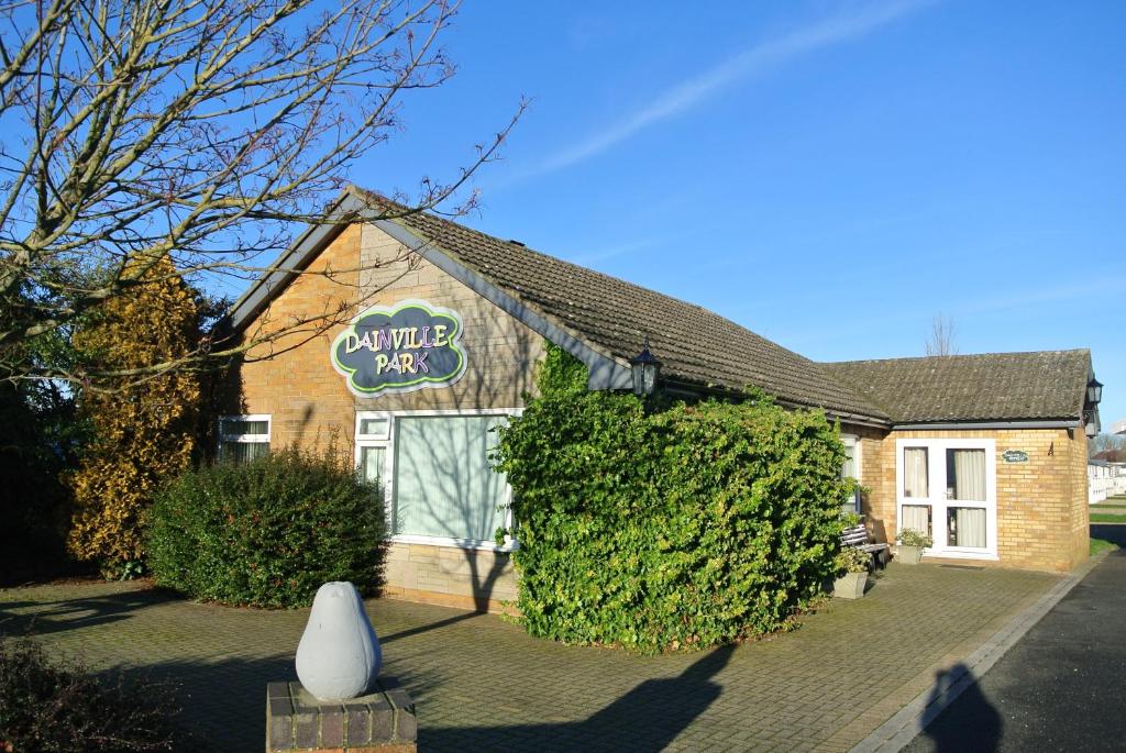 a building with a sign on the side of it at Dainville Retreat in Skegness