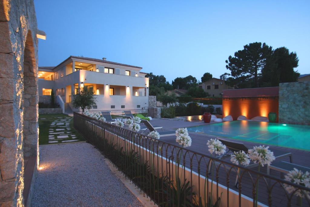een huis met een zwembad en een gebouw bij Residence Catherine in Calvi