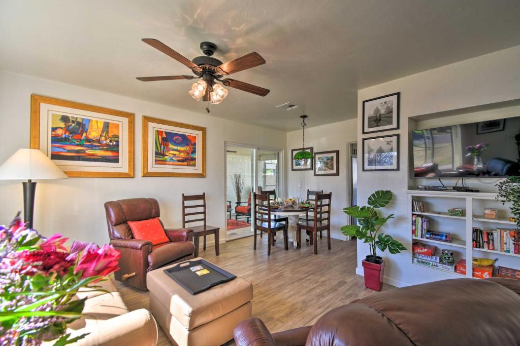 a living room with a ceiling fan and a dining room at Pet-Friendly Phoenix Home with Breezeway and Fire Pit! in Phoenix