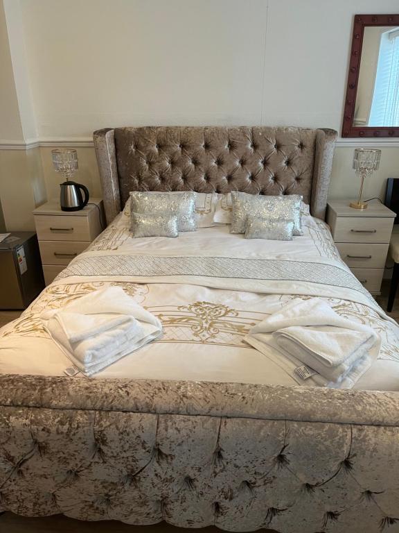 a bedroom with a large bed with a tufted headboard at Jasmine House in Newquay