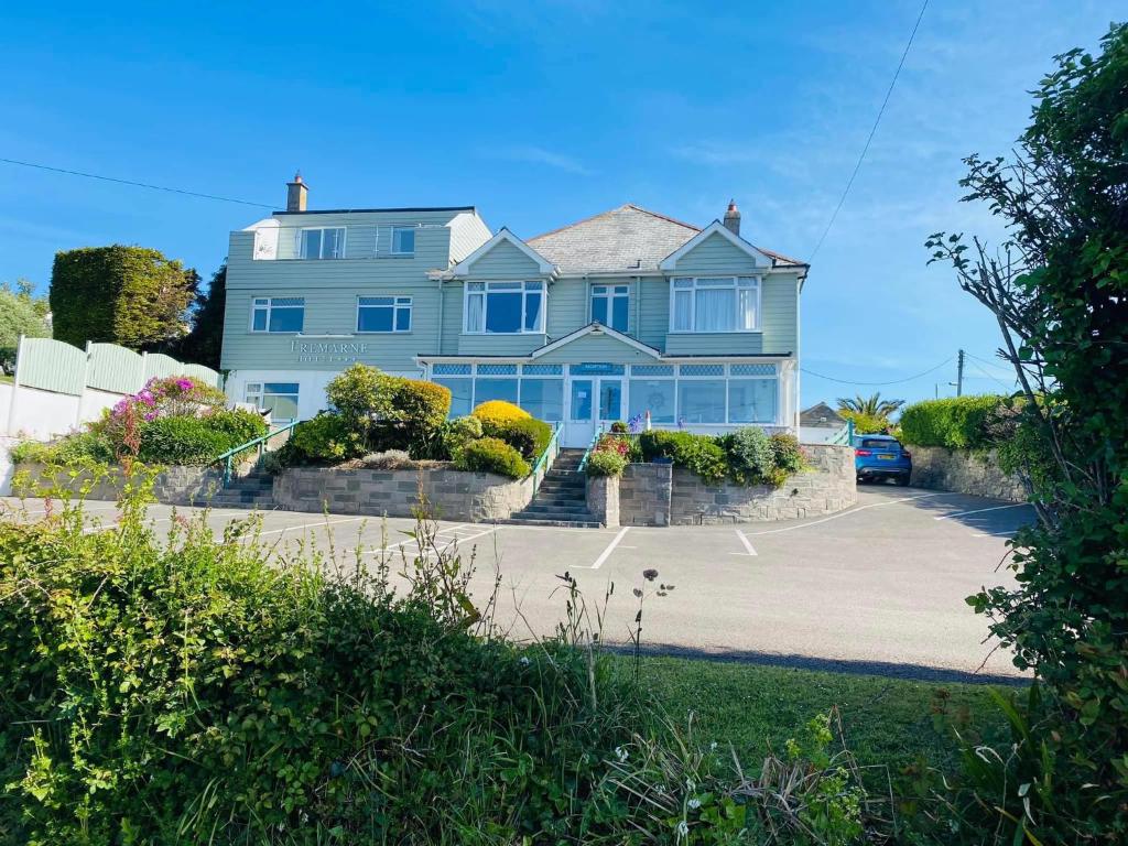 a large blue house with a driveway at Tremarne Hotel in Mevagissey