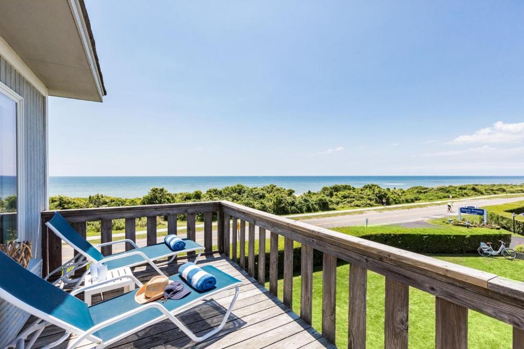 a deck with two lounge chairs and the ocean at Hartman's Briney Breezes Beach Resort in Montauk