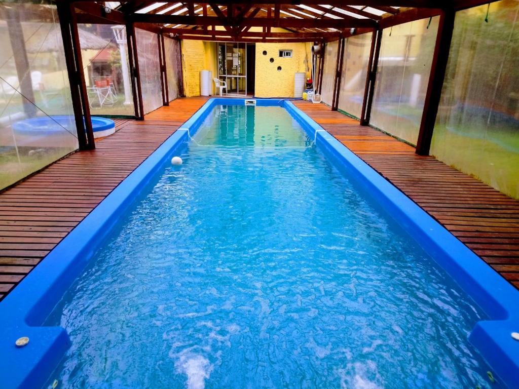 a swimming pool in a house with blue water at San Remo Park Hotel in San Bernardo