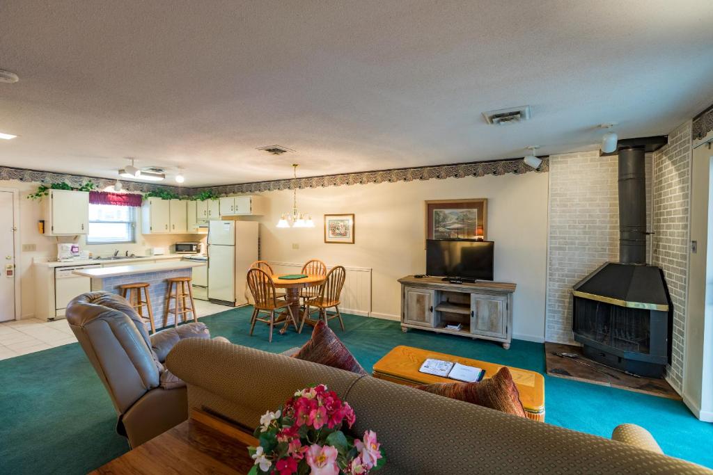 a living room with a couch and a table and a kitchen at Crown Resorts at Lake Tansi East in Crossville