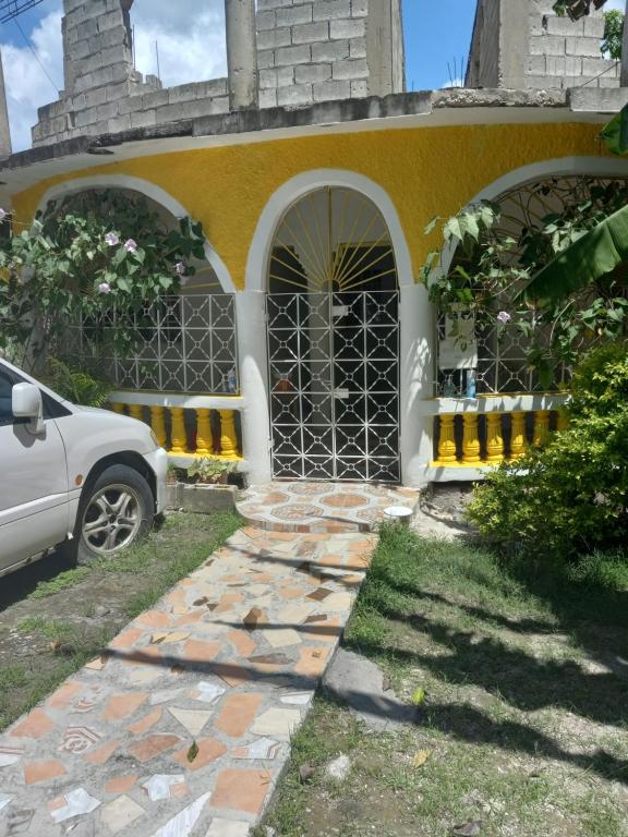 a car parked in front of a house at Fay Guest House in Negril