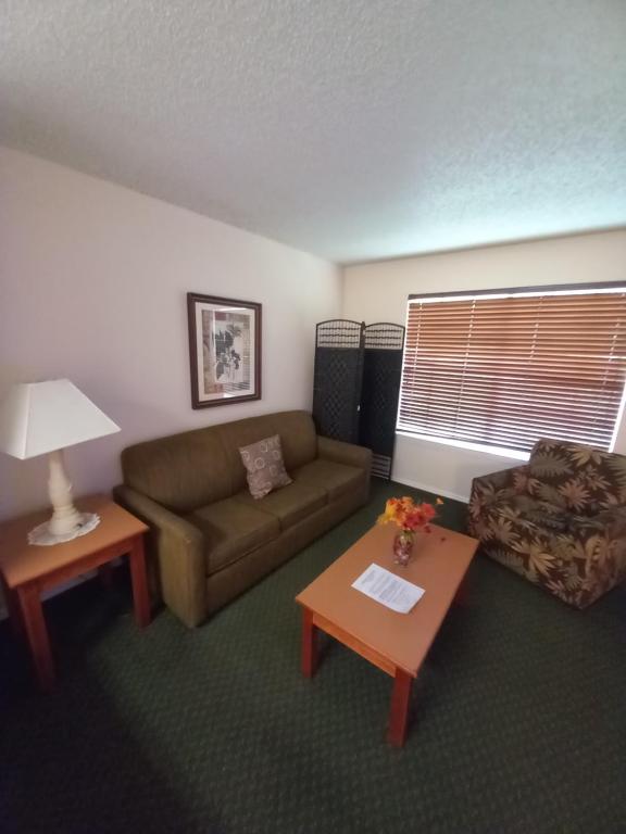 a living room with a couch and a coffee table at #1BR Condo 15Mins To Disney, Universal, Old Town & Parks in Kissimmee