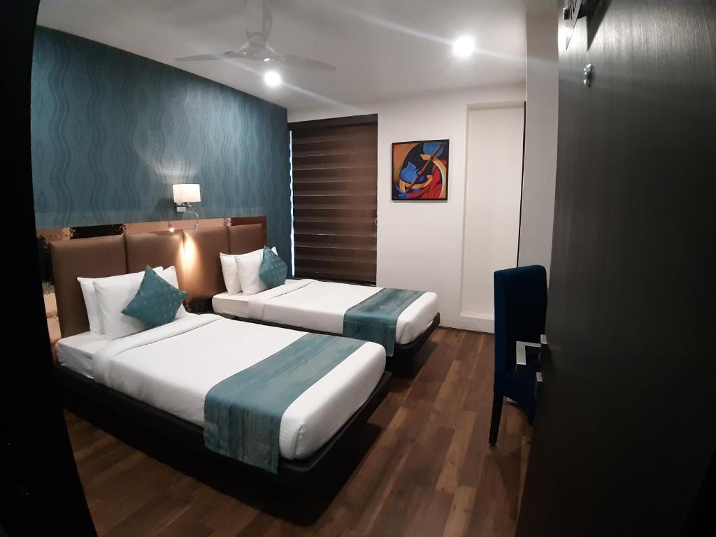 Postel nebo postele na pokoji v ubytování The Opus Kolkata - A Boutique Hotel