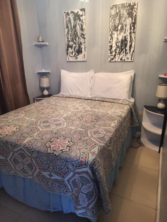 a bedroom with a bed with a quilt on it at Sky Castles Apt J3 in Ocho Rios
