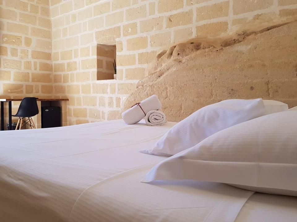 Łóżko lub łóżka w pokoju w obiekcie Residence Masseria Santa Lucia